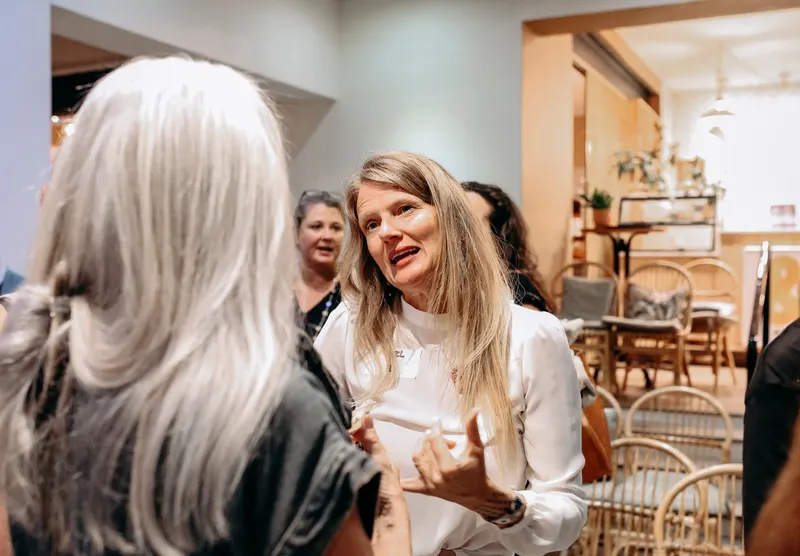 Two women deep in conversation, The Foundation