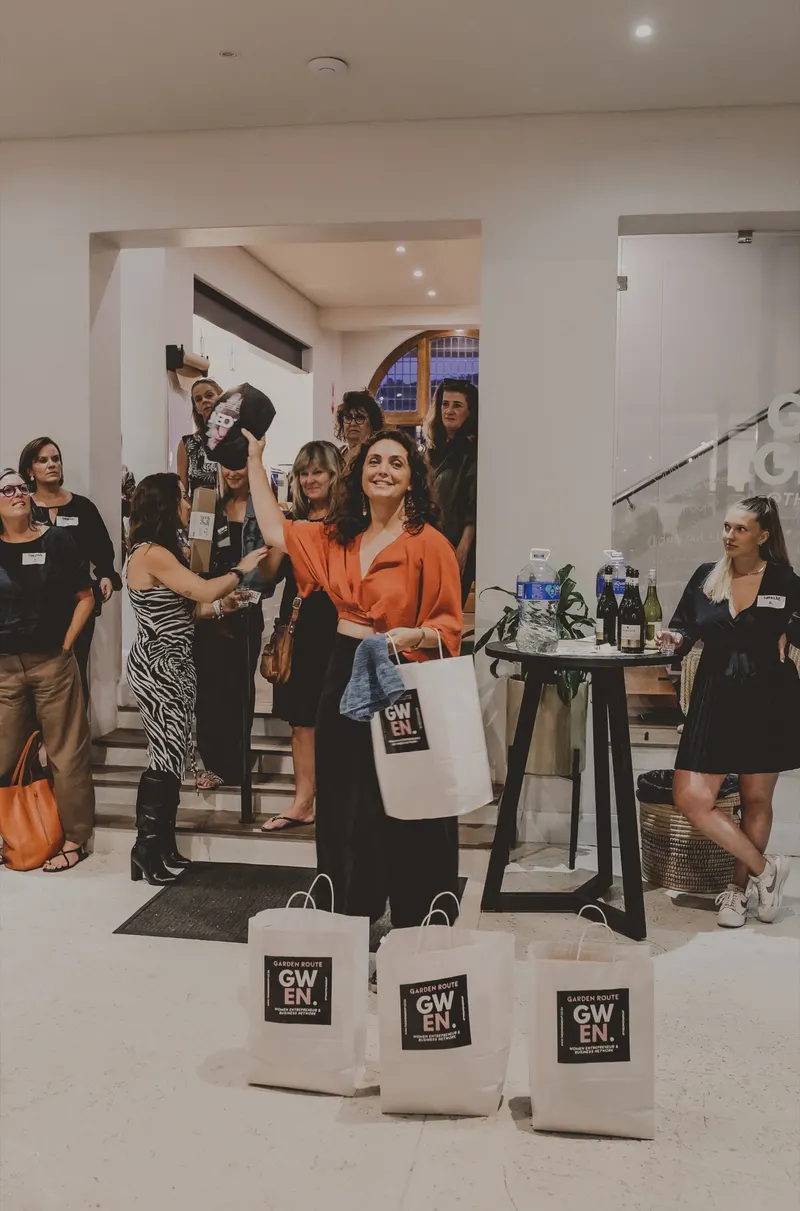 Guests gathered by the GWEN gift bags, February 2025