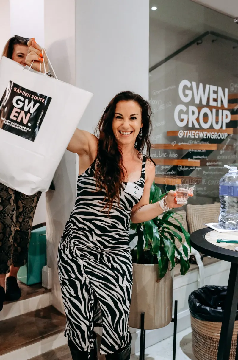 Holding up a GWEN gift bag, February 2025