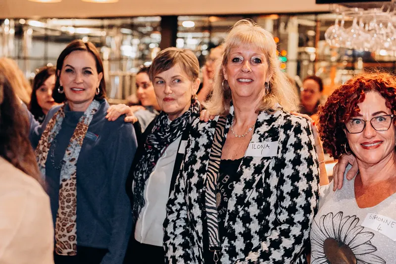 Four women together, smiling, May 2025