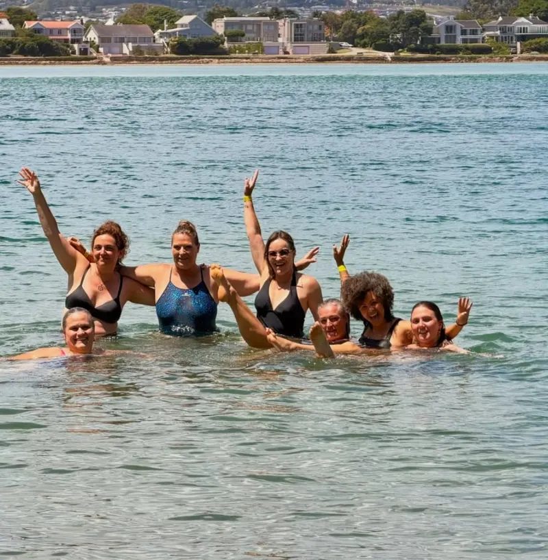 Members laughing in the water at a Members’ Day Out